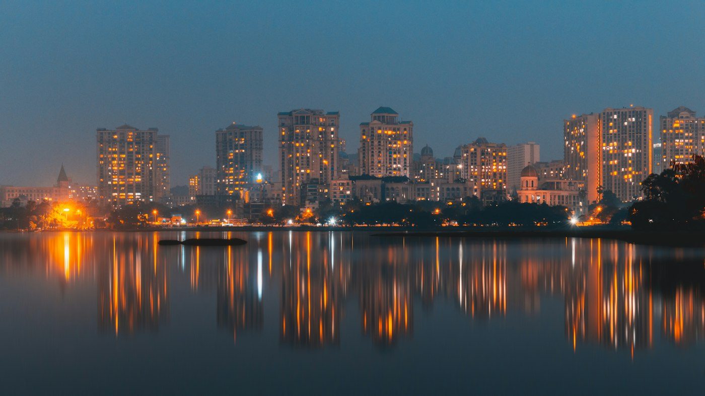Mumbai high-rise towers glowing at night — representative image of our home market